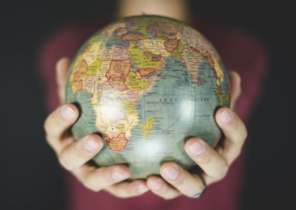 Des mains tenant un globe terrestre, symbolisant la portée mondiale d'International SOS.